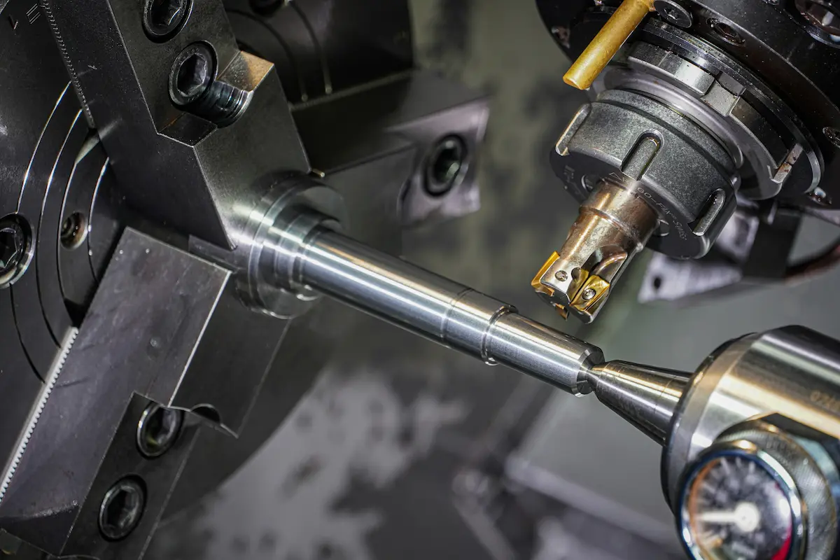 CNC lathe precision turning a steel shaft — automotive component machining
